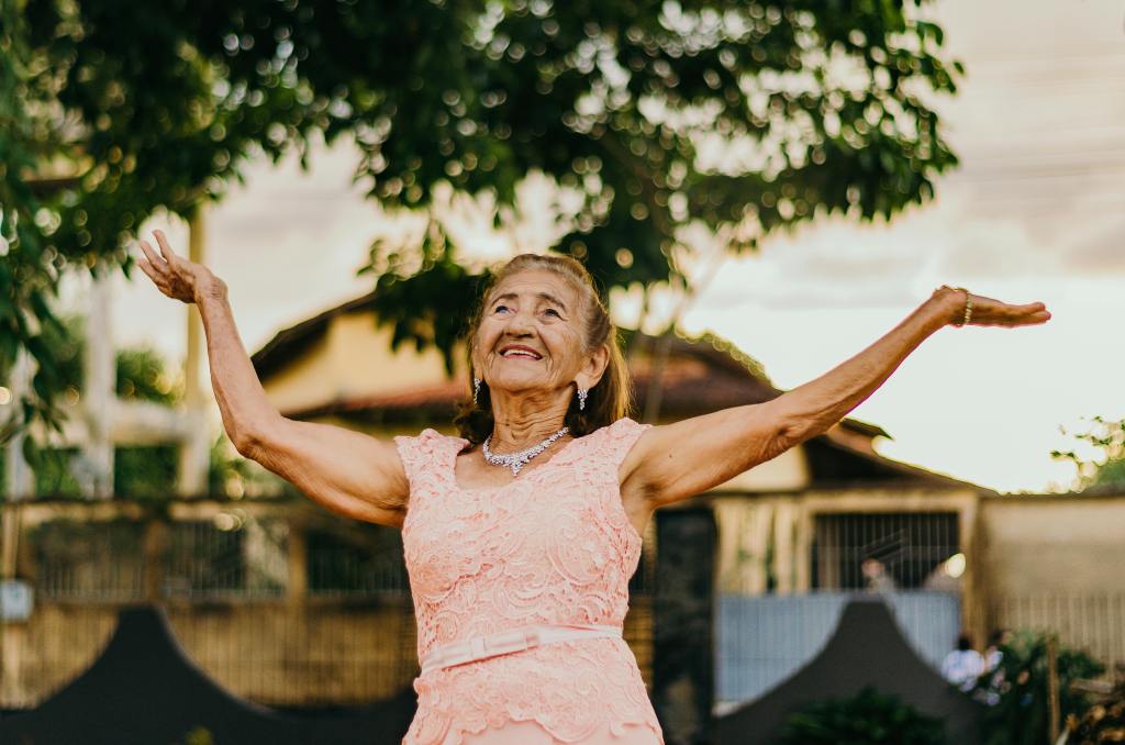 candid photo of older woman wearing a sleevesless dress